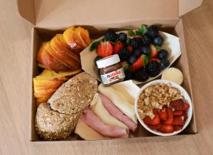 a box filled with different types of fruits and vegetables at VIELA Guest House T2 in Barcelos +14 photos