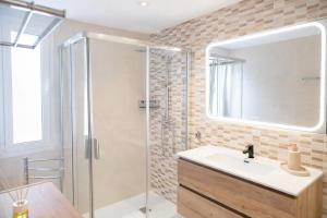 a bathroom with a sink and a shower at Central Torremolinos Luxury Apartment in Torremolinos +21 photos