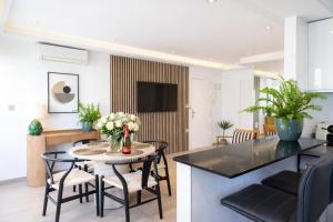a kitchen and living room with a table and chairs at Central Torremolinos Luxury Apartment in Torremolinos