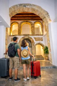 a man and a woman standing with their luggage at Open Sicily Homes - Near the Central Train Station in Palermo