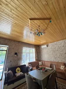 a living room with a couch and a table at Mini Villa in Tel +14 photos
