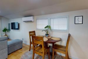 a living room with a table and chairs and a couch at Shore Pine Cottage in Grayland +4 photos