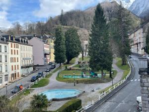 a view of a city with a park and trees at La Cascade appartement F2 in Eaux-Bonnes