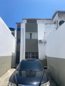 a black car parked in front of a building at Comendador flats350 in Maceió