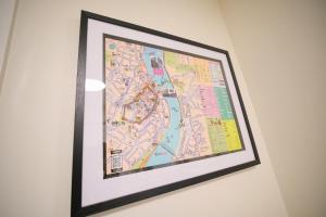 a framed map hanging on a wall at 1 Bedroom Apartment By Travel Lets Holiday Homes Derry Beside The City Walls in Derry Londonderry
