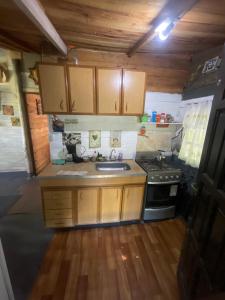 a small kitchen with a stove and a sink at Las calandrias in Barrio Copacabana