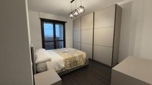 a bedroom with a bed and a window at Urban Nest Living in Sesto San Giovanni