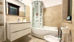 a bathroom with a shower and a sink and a tub at Urban Nest Living in Sesto San Giovanni