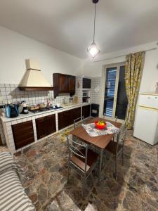 a kitchen with a table and a stove top oven at La casa di Nerone in Acireale