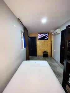 a bedroom with a bed and a tv on the wall at Hotel Mi Palermo in Bucaramanga