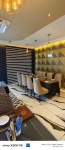 a dining room with a long table and chairs at Hotel Velina in Dhāmpur
