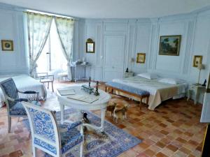 a bedroom with a bed and a dog in it at Manoir de la Chapelle in Alençon