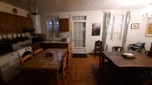 a kitchen and dining room with a table and chairs at Maison avec cour et jardin in Marolles-sur-Seine +9 photos
