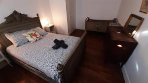 a bedroom with a bed with a cross on it at Maison avec cour et jardin in Marolles-sur-Seine