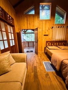 a living room with two beds and a couch at Orelia villas in Badulla +41 photos
