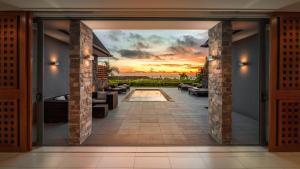 an open door to a patio with a sunset at InterContinental Fiji Golf Resort & Spa by IHG in Natadola