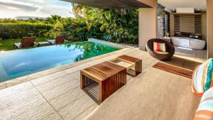 a swimming pool in a villa with a table and chairs at InterContinental Fiji Golf Resort & Spa by IHG in Natadola