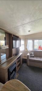 a living room with a couch and a fireplace at BILOT Caravan in Heysham