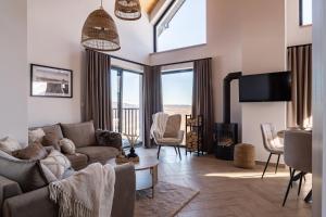 a living room with a couch and a fireplace at Skalne Wzgórze in Ochotnica Dolna