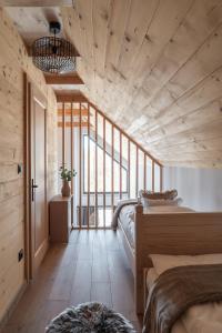 a bedroom with two beds and a large window at Skalne Wzgórze in Ochotnica Dolna +52 photos