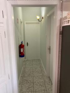 a hallway with a fire extinguisher on the wall at Casa da Baía da Manhenha in Manhenha