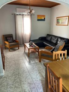 a living room with a couch and a table at Casa da Baía da Manhenha in Manhenha