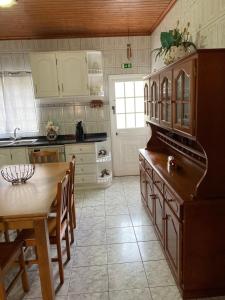a kitchen with a table and a dining room at Casa da Baía da Manhenha in Manhenha +11 photos