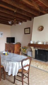 a living room with a table and a fireplace at Gite à Lulu in Châteauvieux