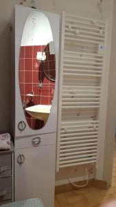 a bathroom with a sink and a mirror on a dresser at Gite à Lulu in Châteauvieux +7 photos