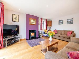 a living room with a couch and a fireplace at Highfields in Runswick