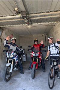 three people on dirt bikes in a garage at Il Sogno in Como