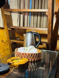 a tea pot and a basket on a table at Orelia villas in Badulla