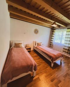 a bedroom with two beds and a window at WERK 2 - B&B Ecoturistic - Saschiz in Saschiz