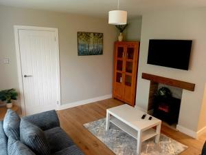 a living room with a couch and a coffee table at Martindale Close - 3 Bedrooms - Sleeps 5 in Whitehaven
