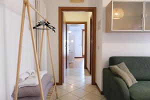 a living room with a green couch and a camera at Casa Segantini - Relax Apartment 2 in Arco