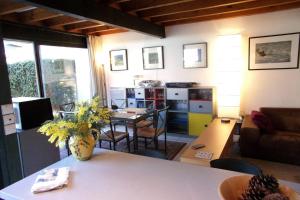 a living room with a vase of flowers on a table at Beautiful 67 m duplex with gardengolf view in Moliets-et-Maa