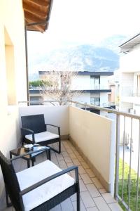 a balcony with two chairs and a table at Casa Segantini - Relax Apartment 2 in Arco