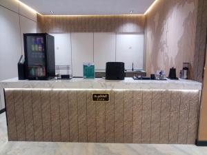 a lobby with a counter with a sign that says call at ﻣﺆﺳﺴﺔ ﺷﻘﻖ ﺍﻟﻘﺎﺭﺍﺕ ﺍﻟﺴﺒﻊ ﺍﻟﻤﺨﺪﻭﻣﺔ in Raḩīmah
