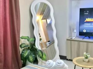 a white mirror in a room with a table at STUDIO TYPE CEBU CITy in Cebu City +4 photos