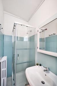 a bathroom with a sink and a glass shower at Santa Caterina 3 - San Bernardo in Crema +18 photos