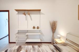 a room with white walls and white stairs at Santa Caterina 3 - San Bernardo in Crema