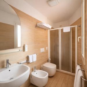 a bathroom with a sink and a toilet and a shower at Hotel Fiamma & SPA Cesenatico in Cesenatico +95 photos