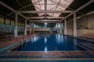 a large swimming pool in a large building at Griya Astoeti By ARBA in Kopo 2