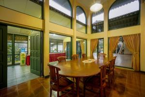 a large dining room with a wooden table and chairs at Griya Astoeti By ARBA in Kopo 2