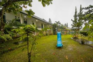 a garden with a blue object in the grass at Griya Astoeti By ARBA in Kopo 2