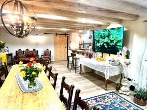 a living room with a long table and a dining room at Casale Sol Armonie in Codroipo