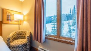 a room with a chair and a window with a view at Cahilty #225 home in Sun Peaks