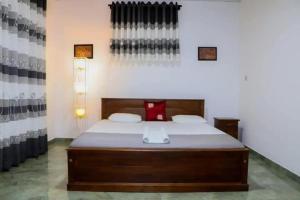 a bedroom with a large bed in a room at Blue Moon Villa in Waskaduwa