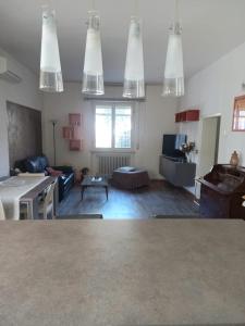 a living room with a table and several lights at Flat26 in Castiglion Fiorentino