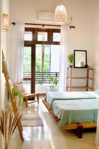 a bedroom with two beds and a large window at Blue Moon Villa in Waskaduwa +42 photos